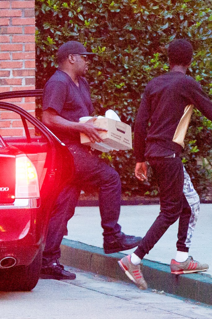 Bobby Brown brings some materials to his daughter's hospice as he arrives with uncle Ray. Photo: AKM-GSI