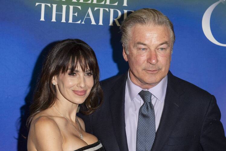 Hilaria Baldwin posing with husband Alec Baldwin on the red carpet at a theater event